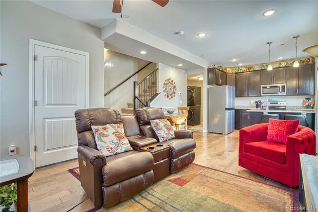 a living room with furniture and kitchen view