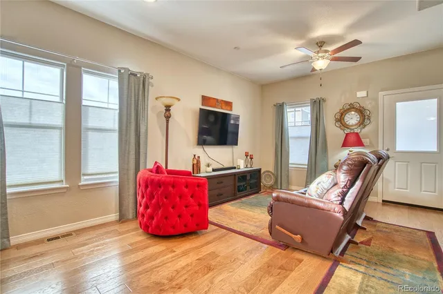a living room with furniture window and flat screen tv