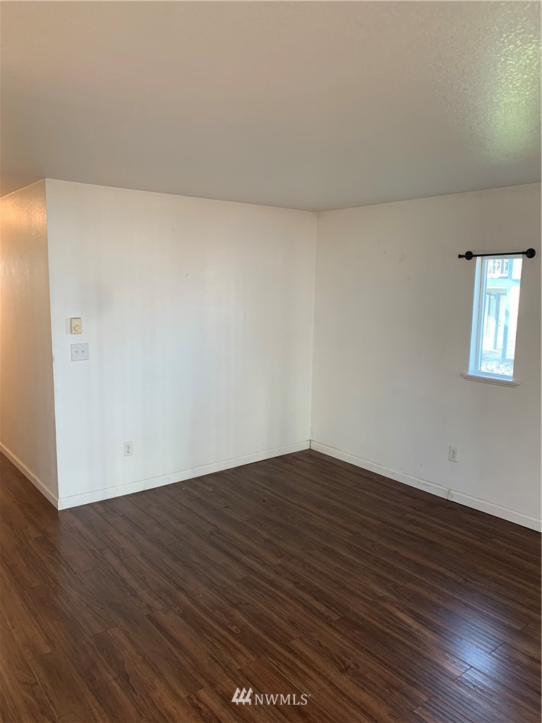 1625 Chestnut Street Everett, WA 98201 - Photo 17 of 27 a view of an empty room with wooden floor and a window