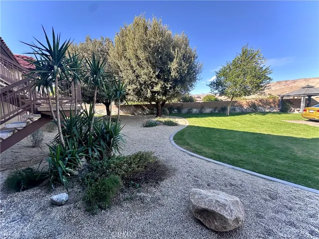 a view of yard with swimming pool and green space