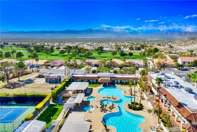 a view of a swimming pool with chairs