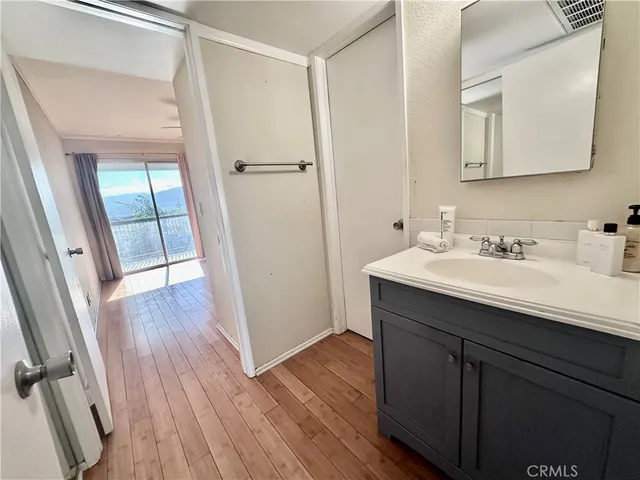 a bathroom with a sink mirror and vanity