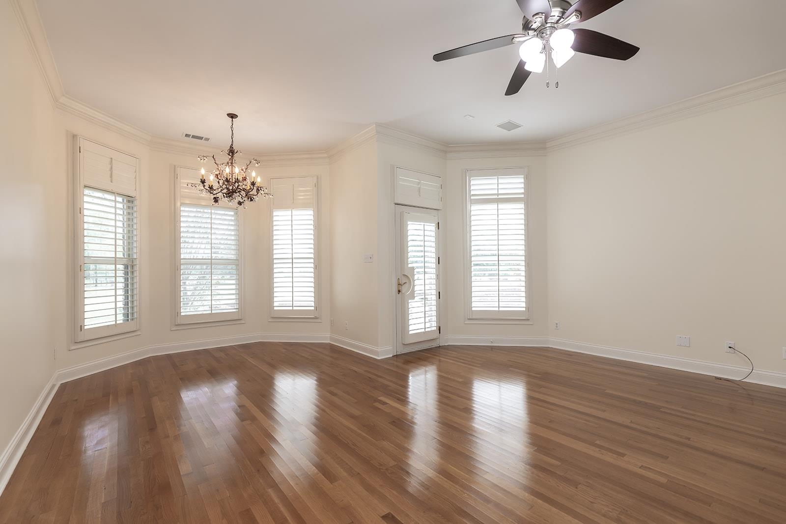 9390 Mayfield Road South Collierville, TN 38017 - Photo 23 of 40 Spare room with dark wood-type flooring, ornamental molding, a chandelier, and ceiling fan