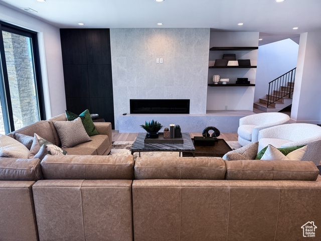 2132 East Outlaw Road, Unit 49 Kamas, UT 84036 - Photo 24 of 44 Living room with a tiled fireplace, recessed lighting, stairs, and built in features