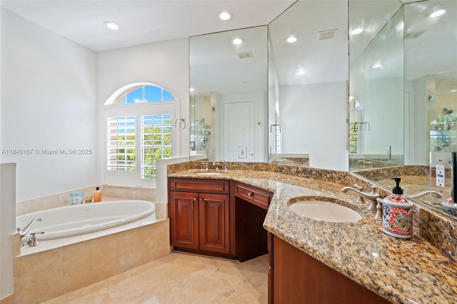 400 Northeast 69th Circle Boca Raton, FL 33487 - Photo 16 of 35 a bathroom with a granite countertop tub sink and mirror