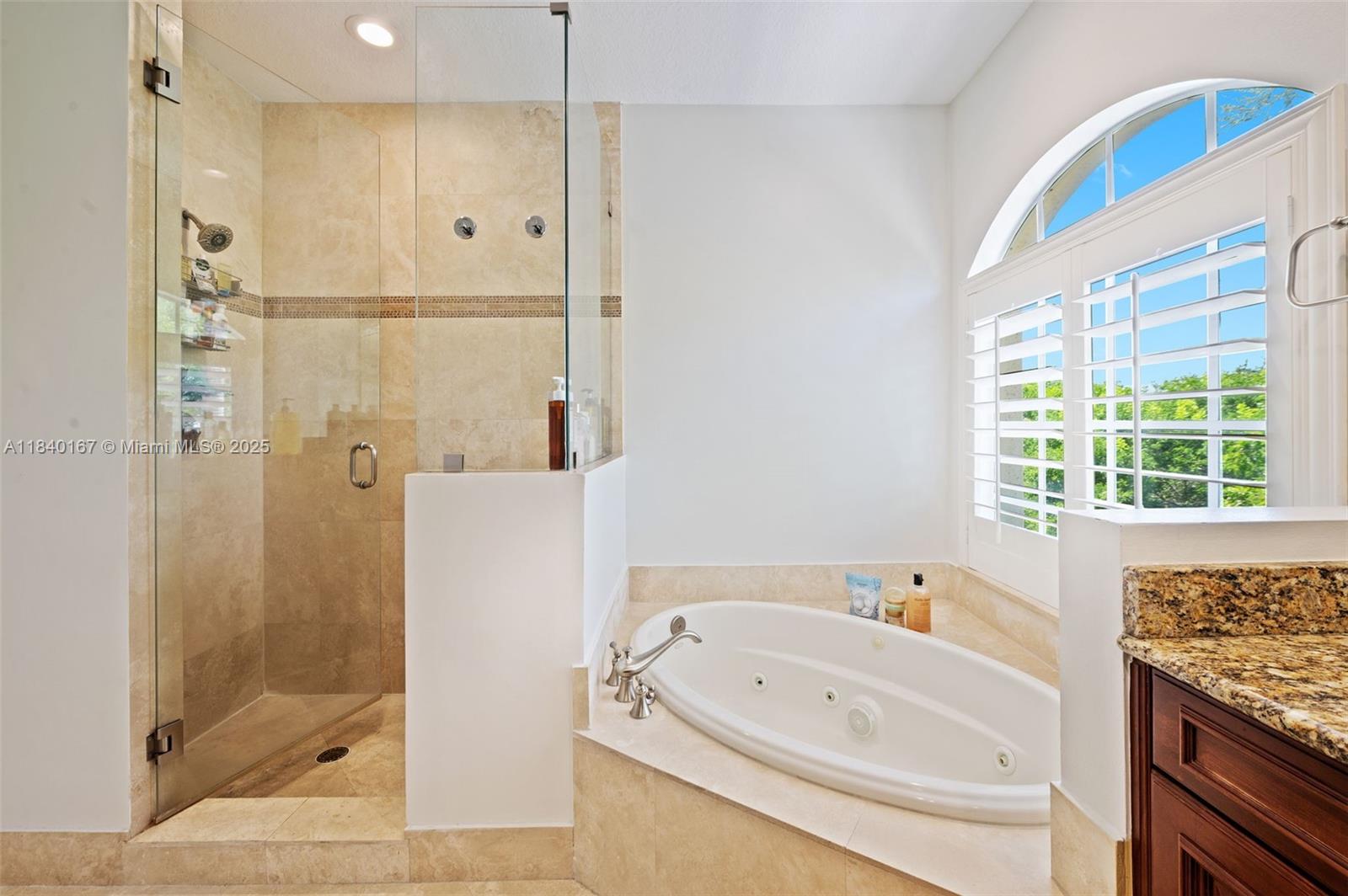 400 Northeast 69th Circle Boca Raton, FL 33487 - Photo 17 of 35 a bathroom with a tub a sink and a shower