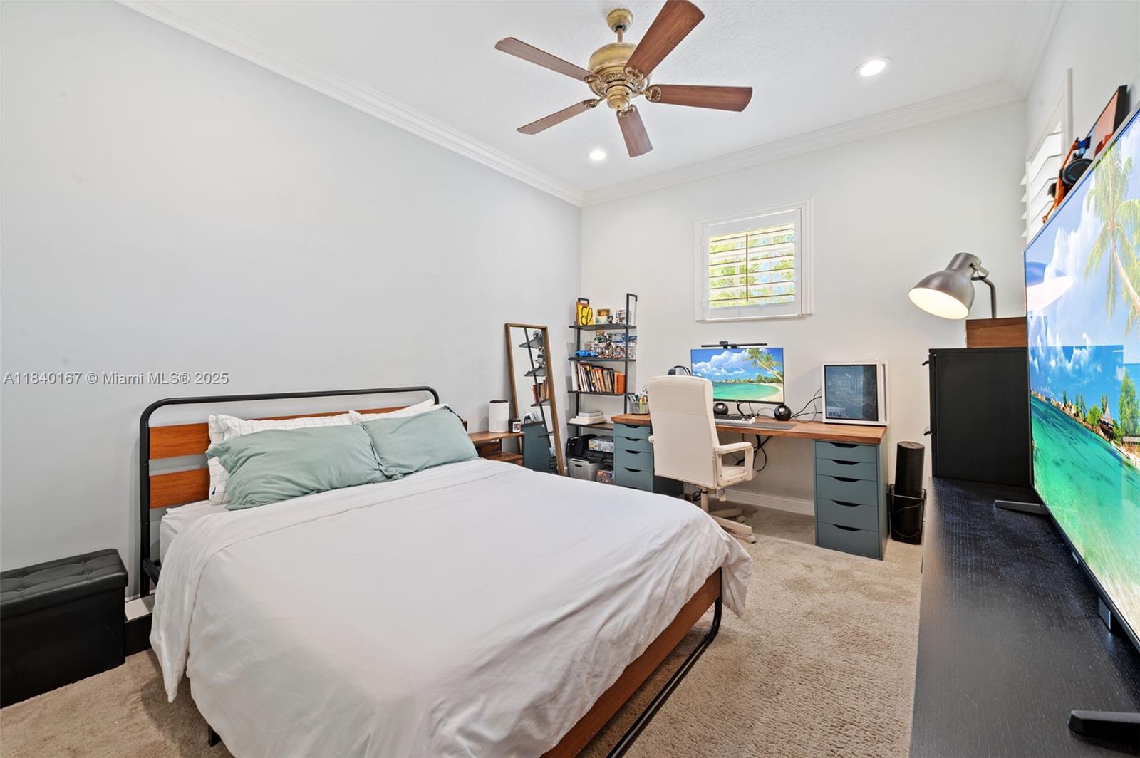 400 Northeast 69th Circle Boca Raton, FL 33487 - Photo 20 of 35 a bedroom with a large bed and a chandelier