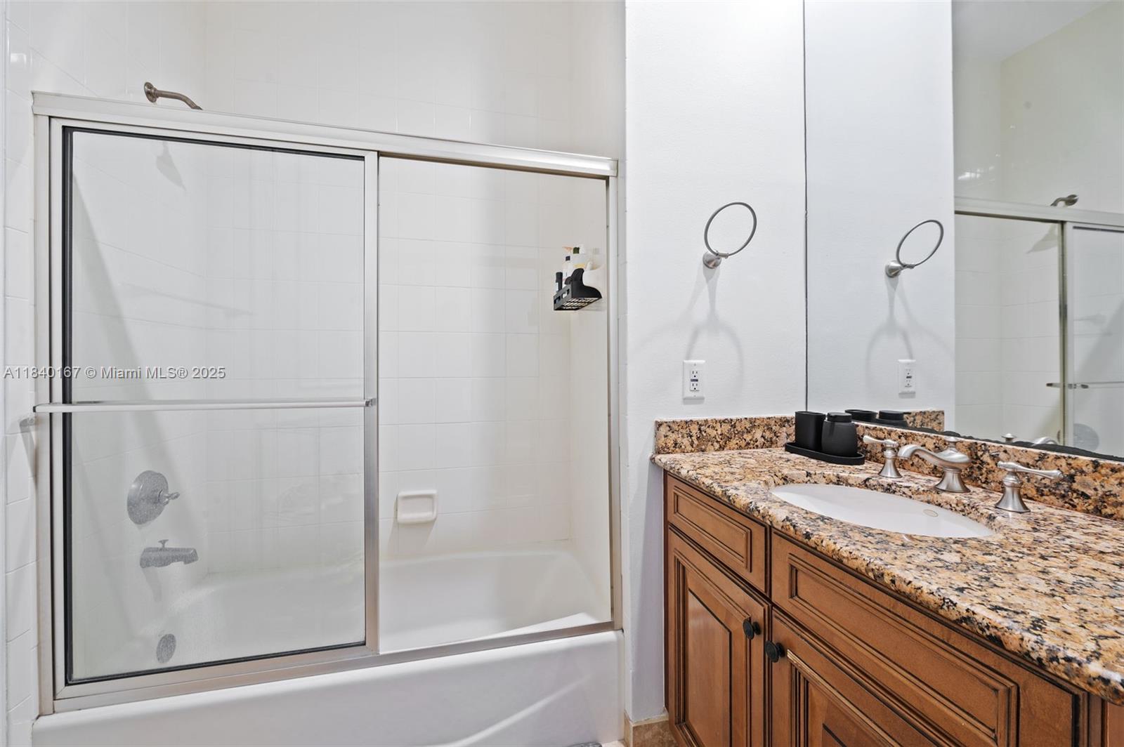 400 Northeast 69th Circle Boca Raton, FL 33487 - Photo 21 of 35 a bathroom with a granite countertop sink and shower