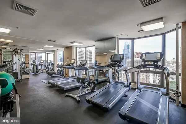 a gym room with lots of gym equipment
