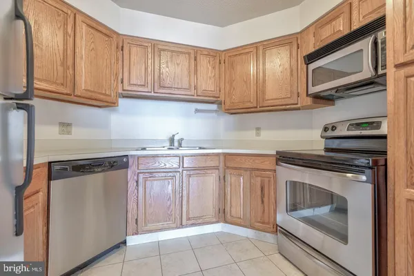 a kitchen with stainless steel appliances granite countertop a stove microwave and sink