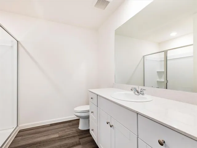a bathroom with a sink a toilet and mirror