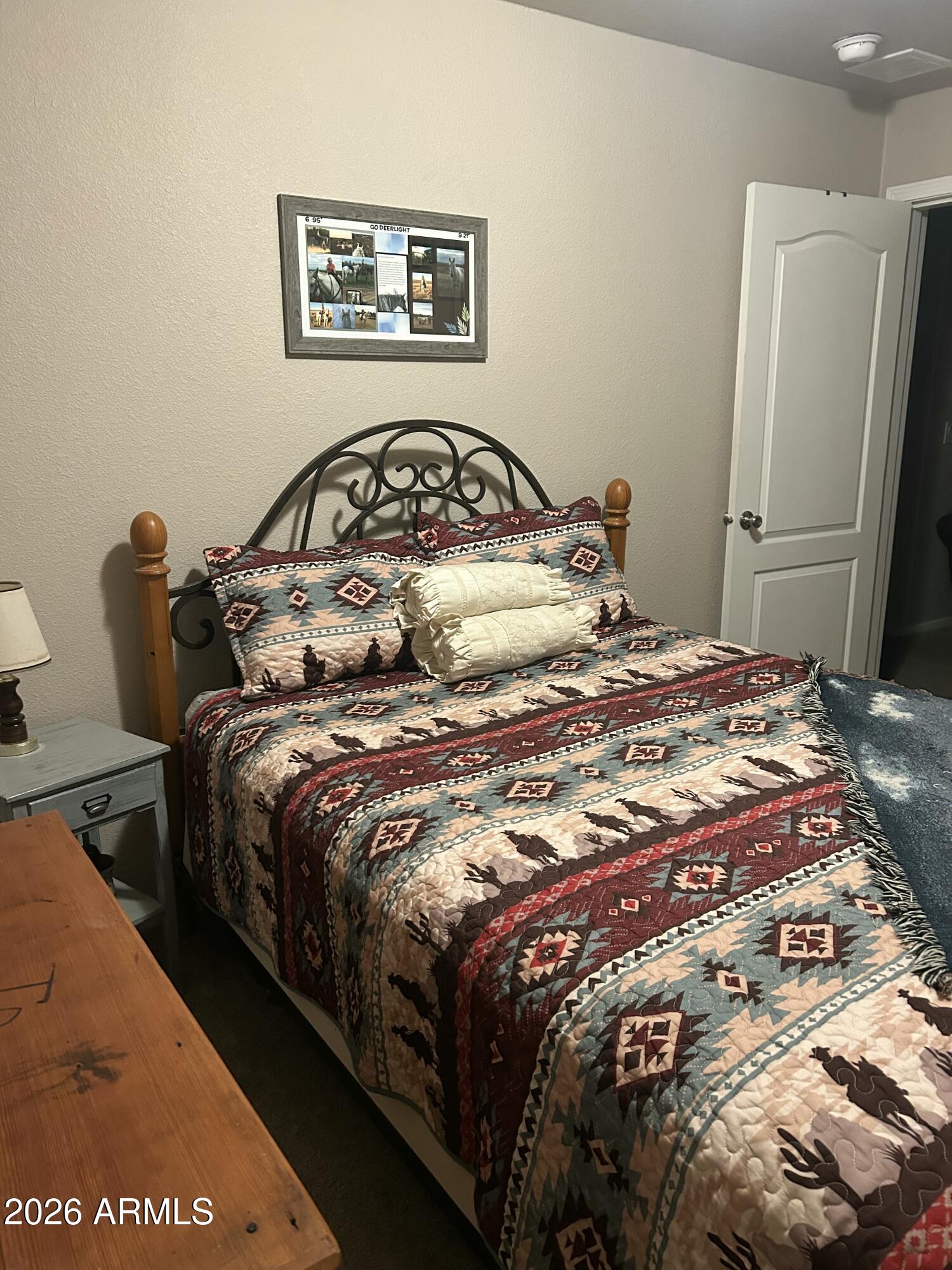11873 North Reed Road Florence, AZ 85132 - Photo 17 of 21 a bedroom with a bed and wooden floor