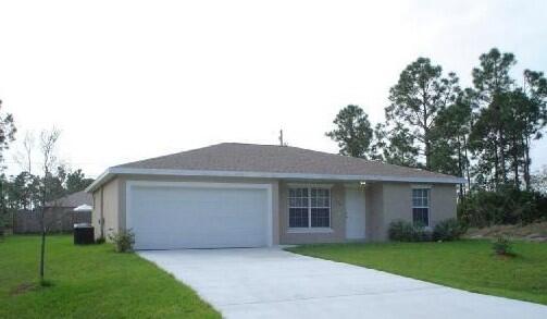 1470 Southwest Gadsan Avenue Port St. Lucie, FL 34953 - Photo 1 of 6 a front view of a house with a garden and yard
