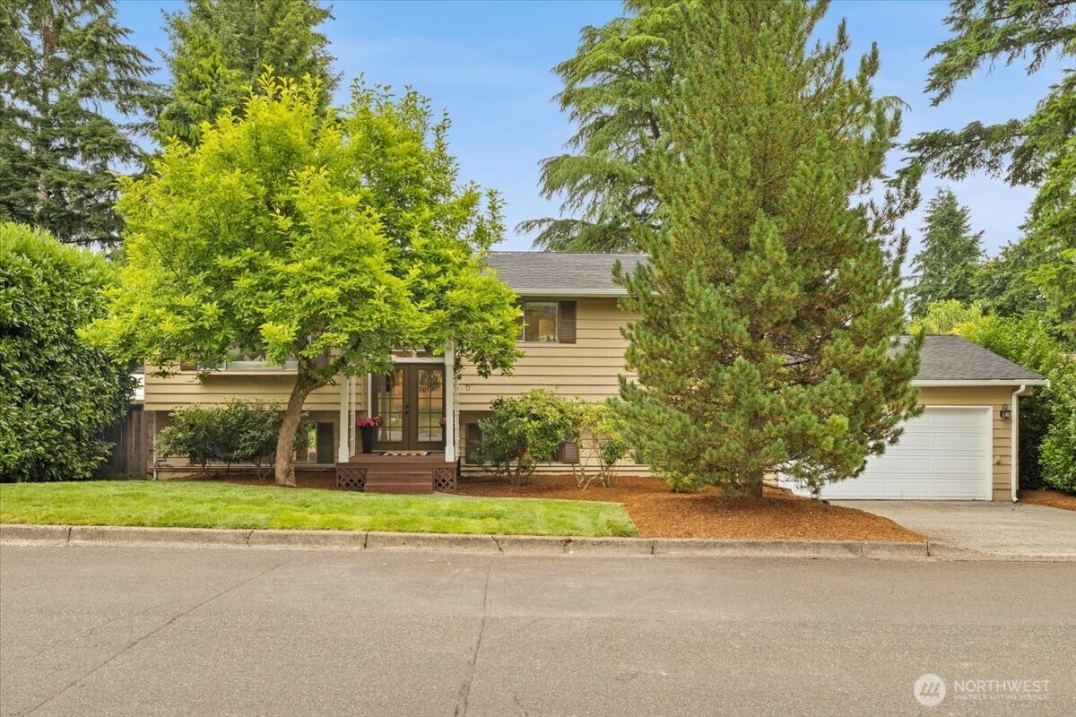 519 220th Street Southwest Bothell, WA 98021 - Photo 1 of 2 a front view of a house with a garden and trees