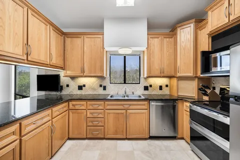 a kitchen with a sink stove and cabinets