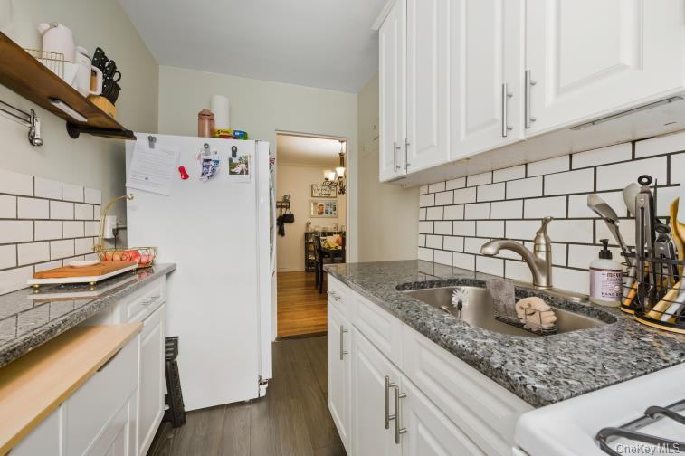 765 Bronx River Road, Unit 2I Bronxville, NY 10708 - Photo 6 of 13 a kitchen with stainless steel appliances granite countertop a sink stove and refrigerator