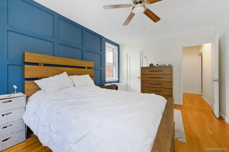 765 Bronx River Road, Unit 2I Bronxville, NY 10708 - Photo 8 of 13 a bedroom with a bed and a chandelier