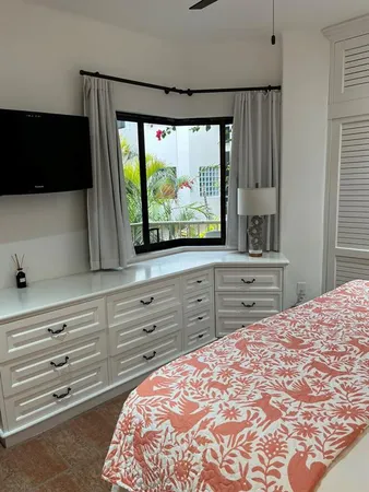 a bedroom with a bed and a television