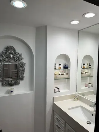 a bathroom with a sink a mirror and shower
