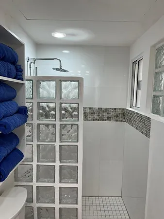 a bathroom with a sink a mirror and a shower