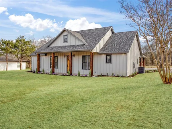 a house with huge green field in front of it