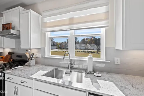 a stove top oven sitting inside of a kitchen