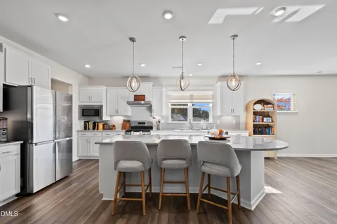 a living room with a fireplace and a potted plant