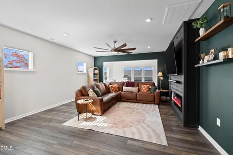 a living room with furniture and kitchen view