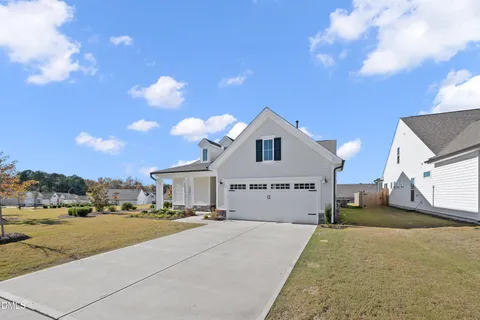 a view of a house with swimming pool and a yard