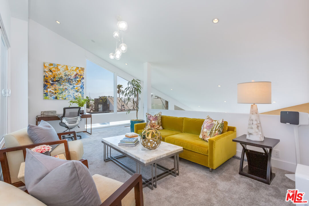 18 Union Jack Street, Unit 302 Marina del Rey, CA 90292 - Photo 13 of 19 a living room with furniture and a lamp
