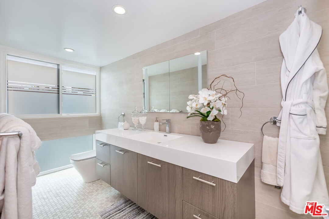 18 Union Jack Street, Unit 302 Marina del Rey, CA 90292 - Photo 14 of 19 a bathroom with a double vanity sink mirror and toilet