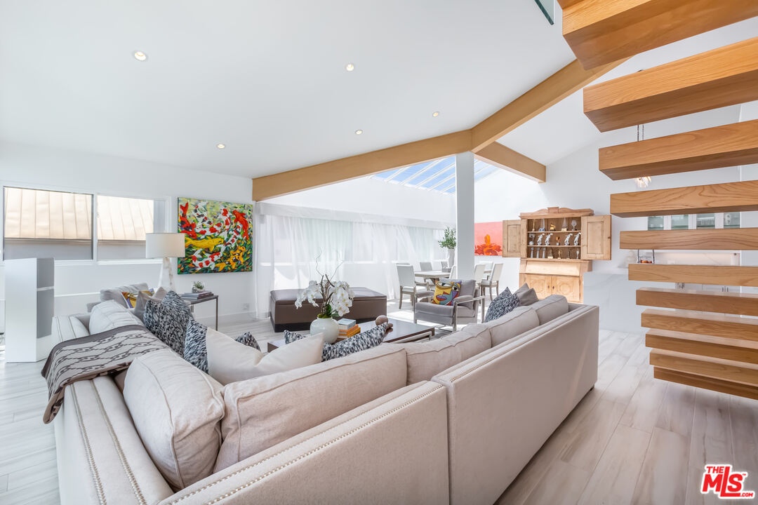 18 Union Jack Street, Unit 302 Marina del Rey, CA 90292 - Photo 4 of 19 a living room with furniture and a floor to ceiling window