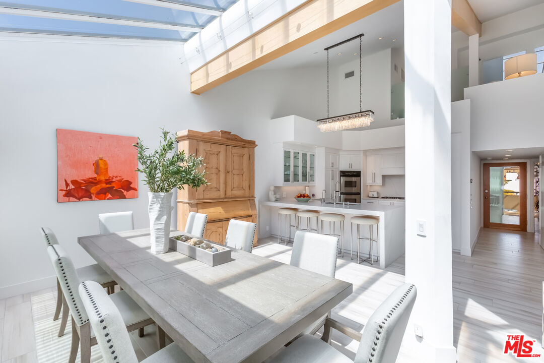 18 Union Jack Street, Unit 302 Marina del Rey, CA 90292 - Photo 6 of 19 a view of a dining room with furniture and wooden floor
