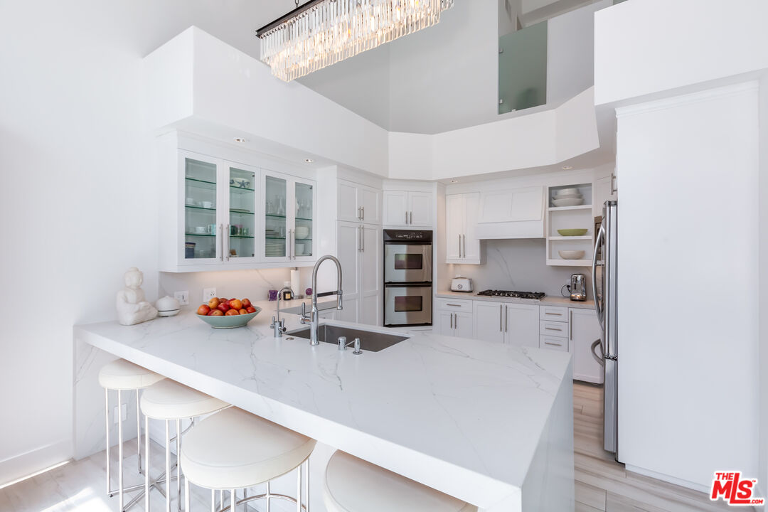 18 Union Jack Street, Unit 302 Marina del Rey, CA 90292 - Photo 8 of 19 a kitchen with stainless steel appliances a sink stove and refrigerator