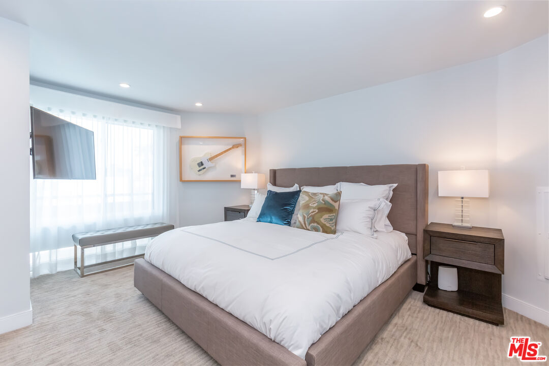 18 Union Jack Street, Unit 302 Marina del Rey, CA 90292 - Photo 10 of 19 a bedroom with a bed and a lamp