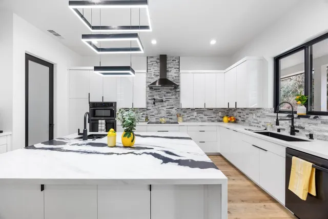 a kitchen with counter top space a sink and appliances