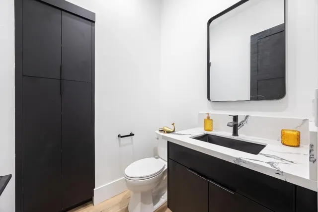 a bathroom with a sink a toilet and mirror