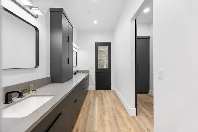 a bathroom with a double vanity sink and a mirror