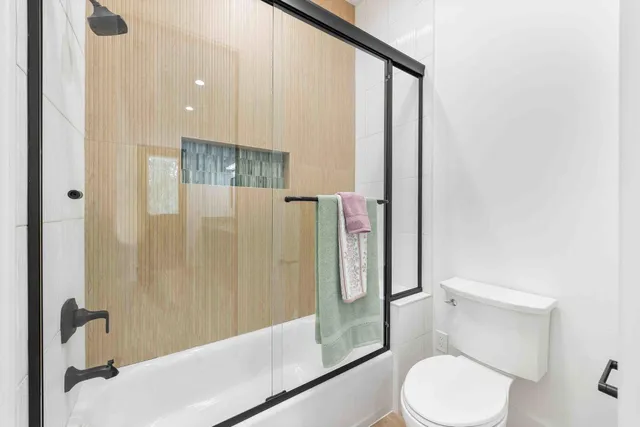 a bathroom with a shower and a toilet