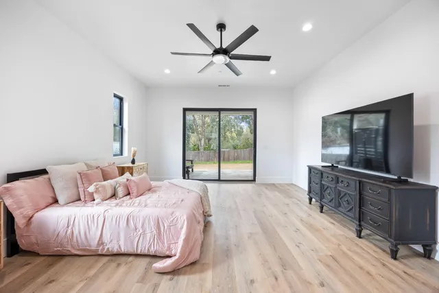 a bedroom with a large bed and a large window
