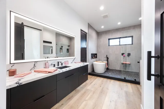 a bathroom with a double vanity sink mirror and toilet
