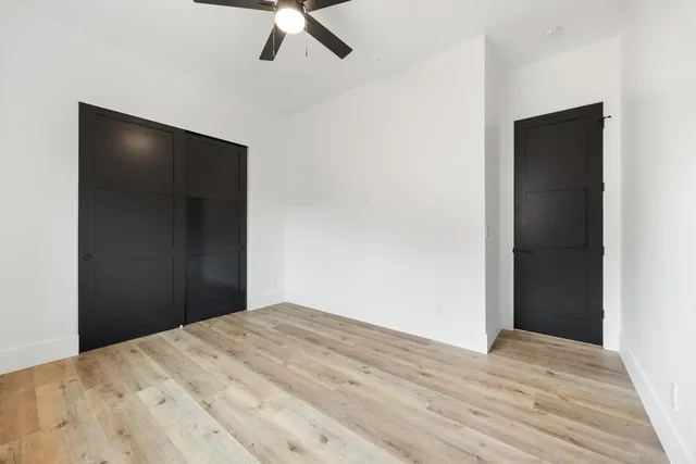 a view of a big room with closet and wooden floor