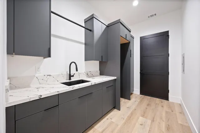 a kitchen with a sink and a refrigerator