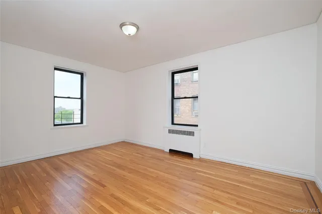 an empty room with windows and closet