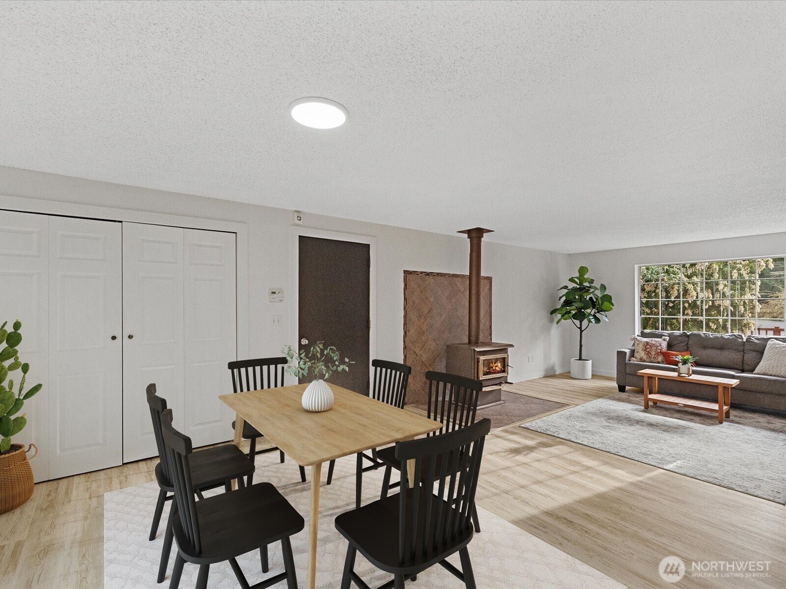 7822 Songbird Way Clinton, WA 98236 - Photo 11 of 38 a view of a dining room with furniture and wooden floor