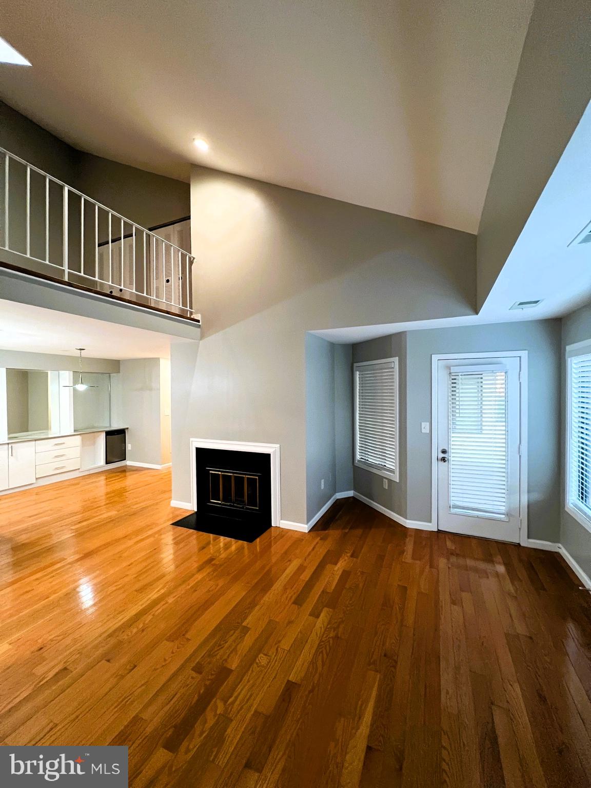 9916 Hellingly Place, Unit 154 Gaithersburg, MD 20886 - Photo 5 of 22 Hardwood floors, vaulted ceiling, and fireplace