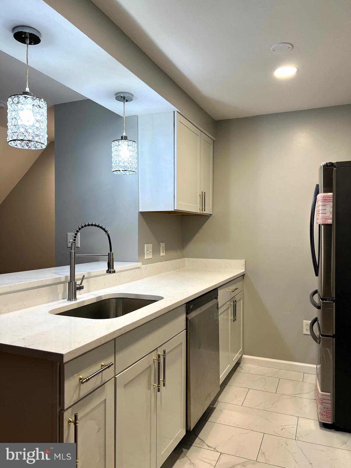 9916 Hellingly Place, Unit 154 Gaithersburg, MD 20886 - Photo 10 of 22 Beautiful quartz counters and pendant lighting