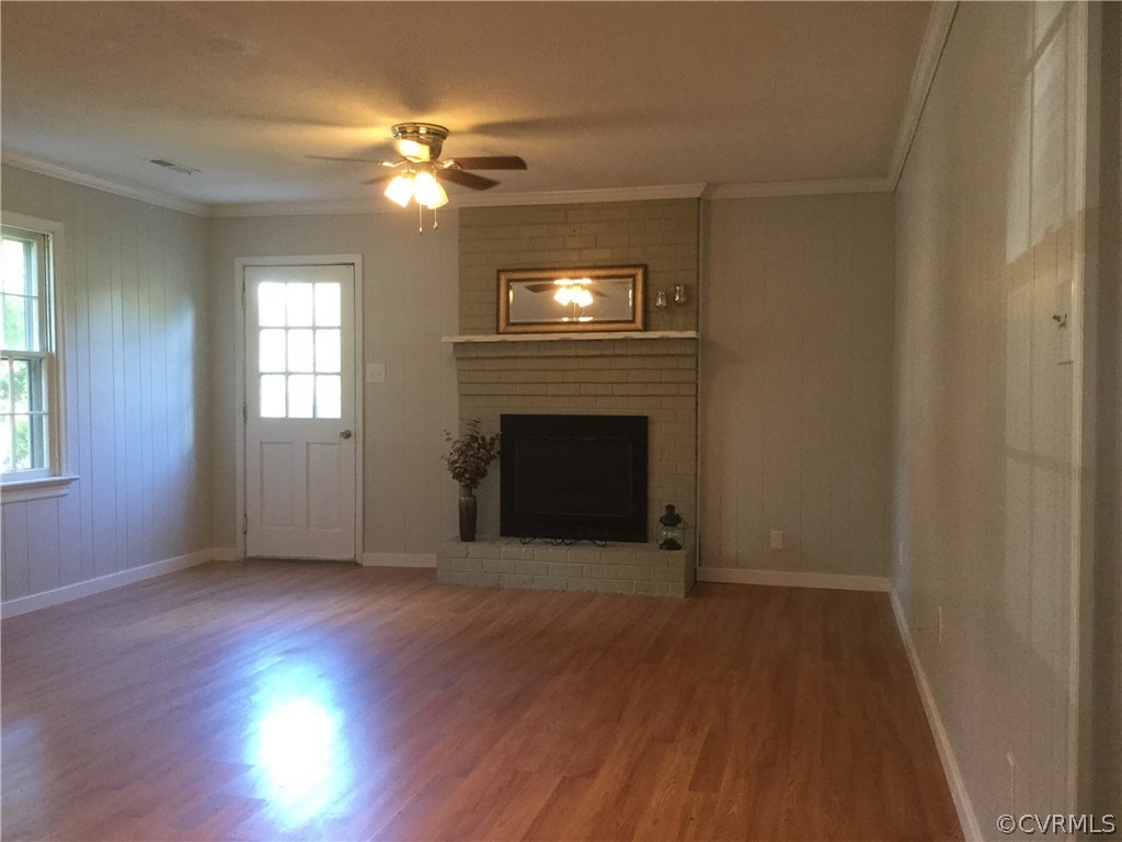 3701 Applewood Road North Chesterfield, VA 23234 - Photo 10 of 15 a view of an empty room with wooden floor fireplace and a window