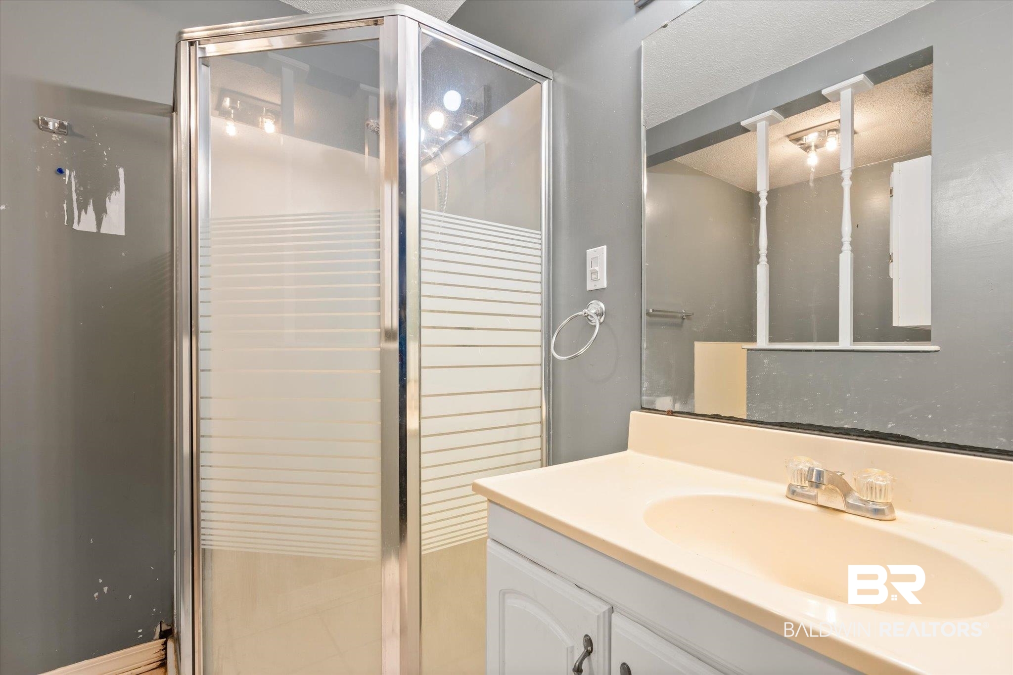3541 Winston Drive Semmes, AL 36575 - Photo 11 of 20 Full bathroom featuring vanity, a shower stall, and a textured ceiling