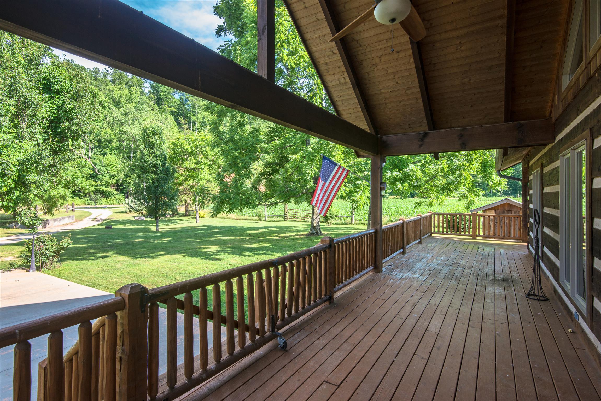 Expansive front covered porch w/ vaulted ceiling and metal roof